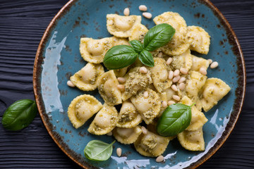 Wall Mural - Closeup of ravioli served with basil pesto sauce and fresh basil