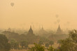 © Sunday Cat Studio - Hot air balloon over plain of Bagan in misty morning before sunr
