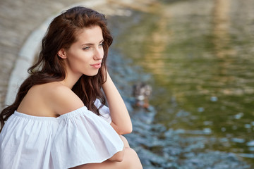 Sticker - Young attractive woman near the lake on a summer day