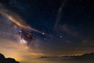 Wall Mural - the colorful glowing core of the milky way and the starry sky captured at high altitude in summertim