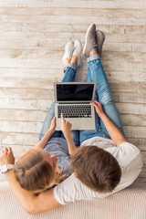 Canvas Print - Beautiful young couple with gadget