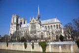 Fototapeta Paryż - Notre Dame cathedral next to Seine river in Paris, France