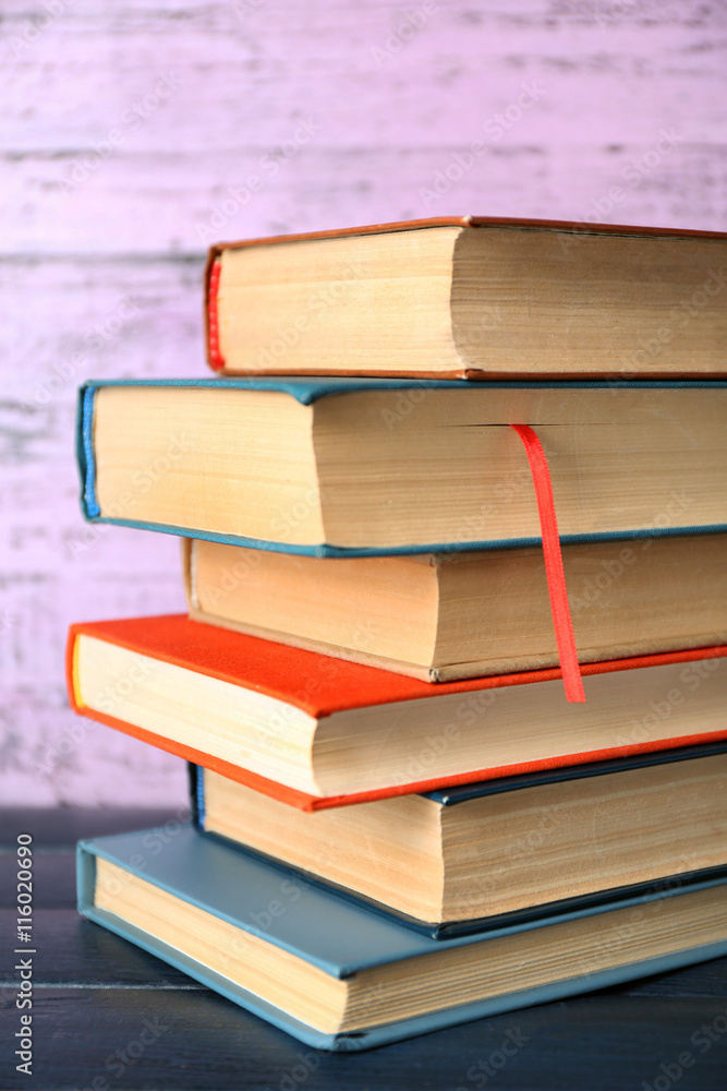 Pile of books on wooden background