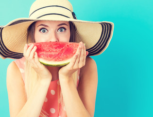 Wall Mural - Happy young woman holding watermelon