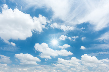 Wall Mural - Blue sky with clouds and sun reflection. looking up view