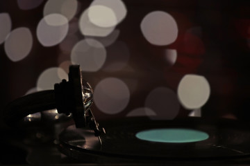 Wall Mural - Turntable with vinyl record on dark blurred background