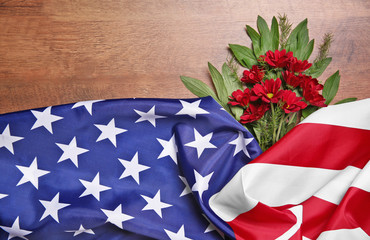 Flowers and American flag on a wooden background