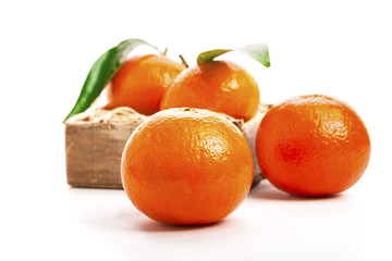 Wall Mural - Ripe mandarines, Tangerines  with leaves on a white background.