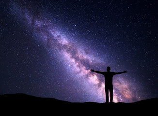 Wall Mural - night landscape with milky way and silhouette of a man