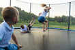 Children are jumping on trampoline
