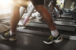 © Syda Productions - close up of men legs walking on treadmills in gym