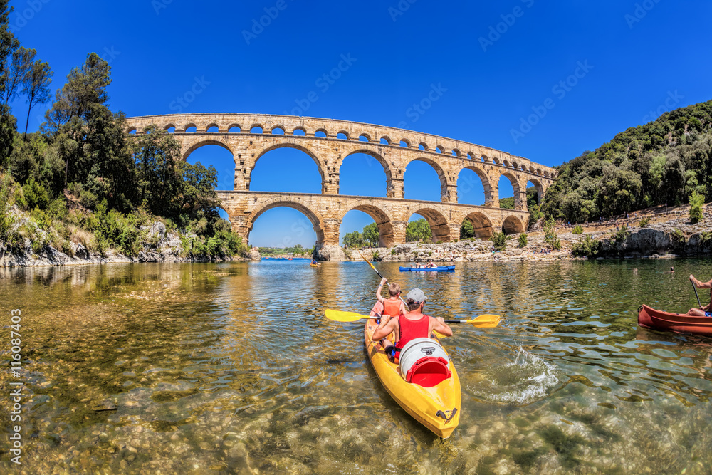 Pont du Gard with paddle boats is an old Roman aqueduct in Provence, France - obrazy, fototapety, plakaty 