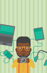 Wall Mural - Young man surrounded with his gadgets.