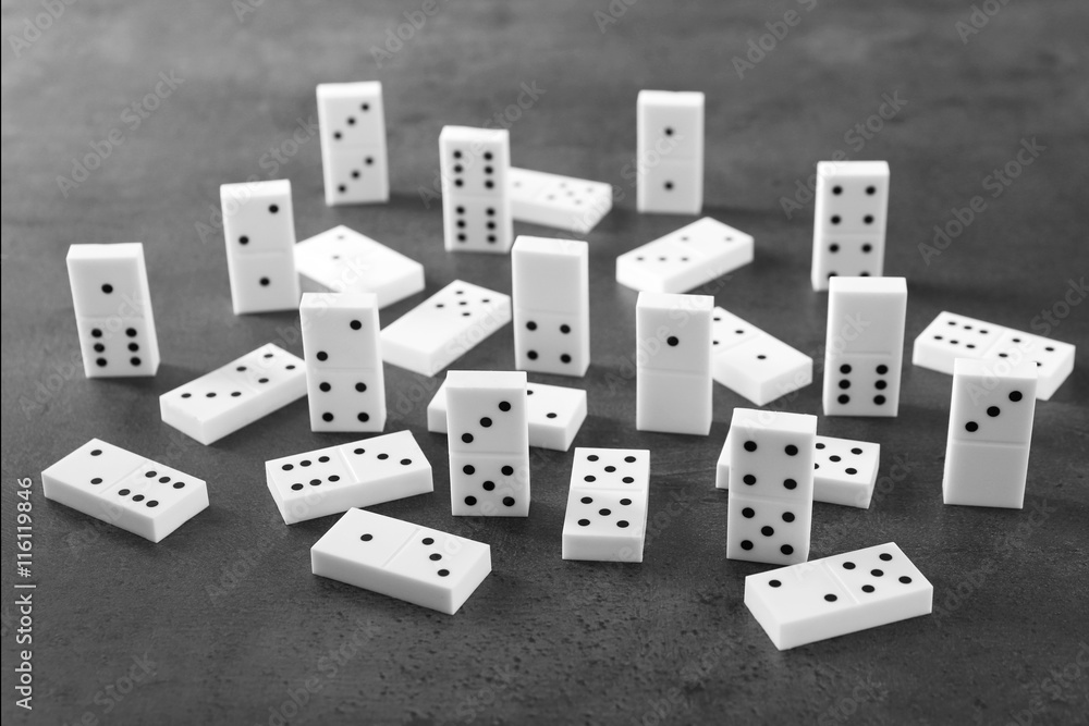Heap of dominoes on grey background