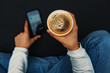 © agcreativelab - Girl with a smartphoen taking a black coffee