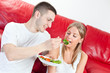 Young couple is having breakfast at their home
