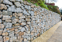 Wire Gabion Rock Fence. Metal Cage Filled With Rocks.