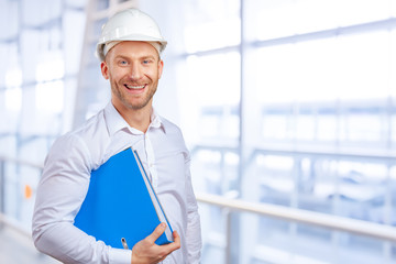 Happy young businessman architect smiling