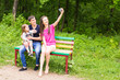 © satura_ - Summer scene of Happy young family taking selfies with her smartphone in the park