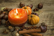 Autumn candle decoration with cinnamon sticks, acorns,anise and