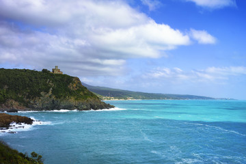 Wall Mural - Cliff rock and building on the sea on sunset. Quercianella, Tusc