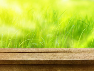 Poster - old wood table top on nature rice field green blur background