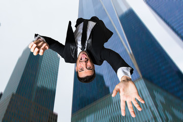 Wall Mural - Fired businessman falling from a skycraper. 