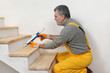 © sima - Home renovation, caulking wooden stairs with silicone