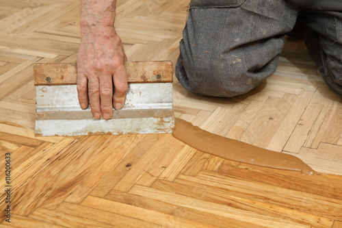 Varnishing Of Oak Parquet Floor Senior Workers Hand And Tool