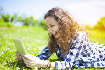 Young woman with tablet in summer