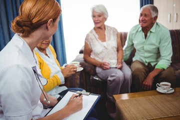 Wall Mural - seniors peoples and nurse seated in a sofa