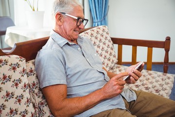 Wall Mural - senior man using a smartphone