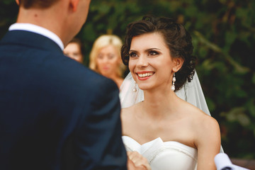 The smilling bride on the wedding ceremony