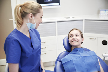 Poster - happy female dentist with patient girl at clinic