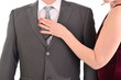 © michelaubryphoto - Woman pulls out wallet from a pocket of the businessman.  Isolated on white background.