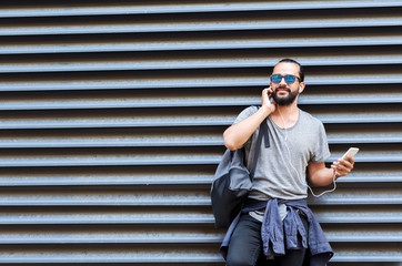 Sticker - man with earphones and smartphone on city street