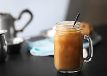 Iced Coffee In Glass Jar On Black Table