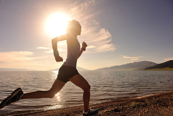 Wall Mural - healthy young fitness woman runner running on sunrise seaside