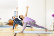 two women doing yoga at home