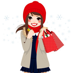 Wall Mural - Beautiful brunette girl shopping on Christmas winter day holding credit card and bags full of gifts and presents