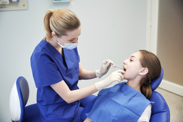 Sticker - female dentist checking patient girl teeth