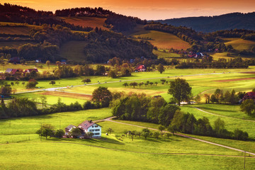 Wall Mural - Scenic countryside landscape: green summer mountain valley with forests, fields and old houses in Germany, Black Forest