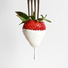 Strawberry Dipped In Cream On A Fork