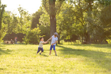 Two Boys Playing In Park