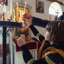 Boy Lightning Candles In A Church