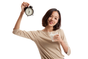 Healthy Asian woman drinking  glass of milk hold clock  isolated on white background