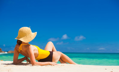 Wall Mural - Fit woman in sun hat and bikini at beach.remote tropical beaches and countries. travel concept
