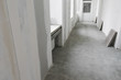 Unfinished apartment interior with door and gray concrete floor
