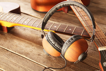 Wall Mural - Guitars and headphones on wooden background