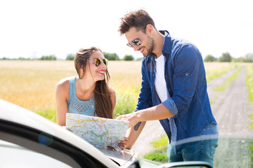 Wall Mural - Couple reading a map while standing near convertible
